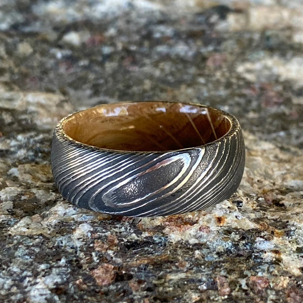 8mm Wide Damascus Steel Ring with a Whiskey Barrel Sleeve Handmade Wedding Band