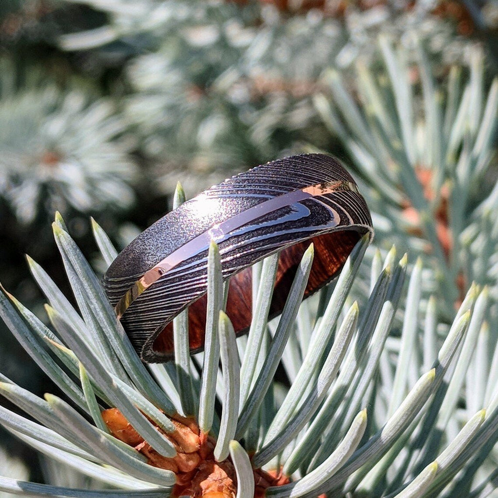 New 7mm Wide Damascus Steel Wedding Band with 14k Solid Rose Gold Inlay and Arizona Ironwood Sleeve