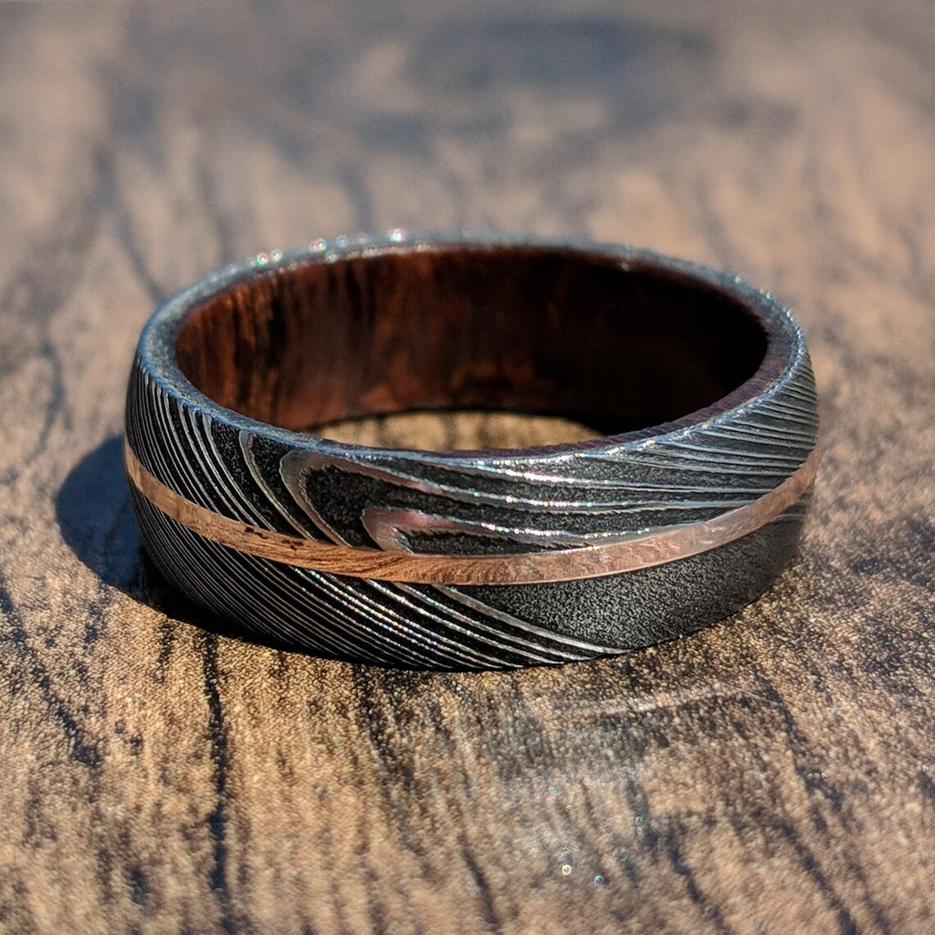 New 7mm Wide Damascus Steel Wedding Band with 14k Solid Rose Gold Inlay and Arizona Ironwood Sleeve